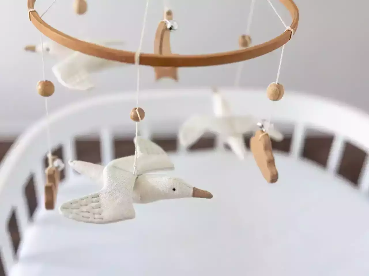 Babybett mit Mobile mit Gänsen